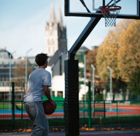 Un joueur sur le terrain de basket près du stade Hélitas